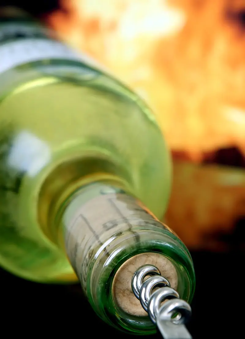 Why does wine in clear bottles often smell like cabbage or wet dog?
