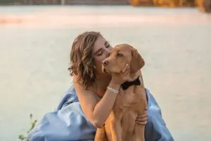 woman kissing dog