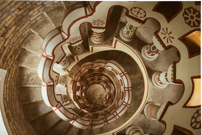 Why are medieval spiral staircases designed to twist clockwise?
