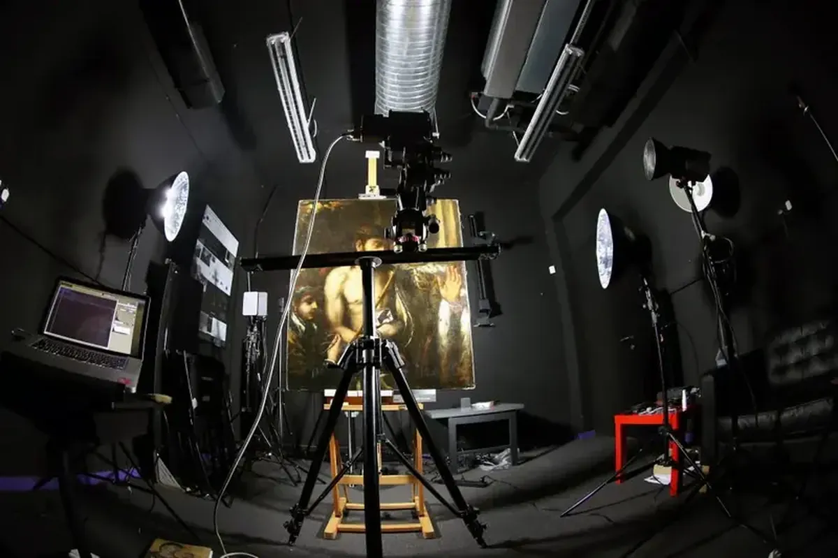 Beneath Titian's masterpiece lay a portrait of a man with books.