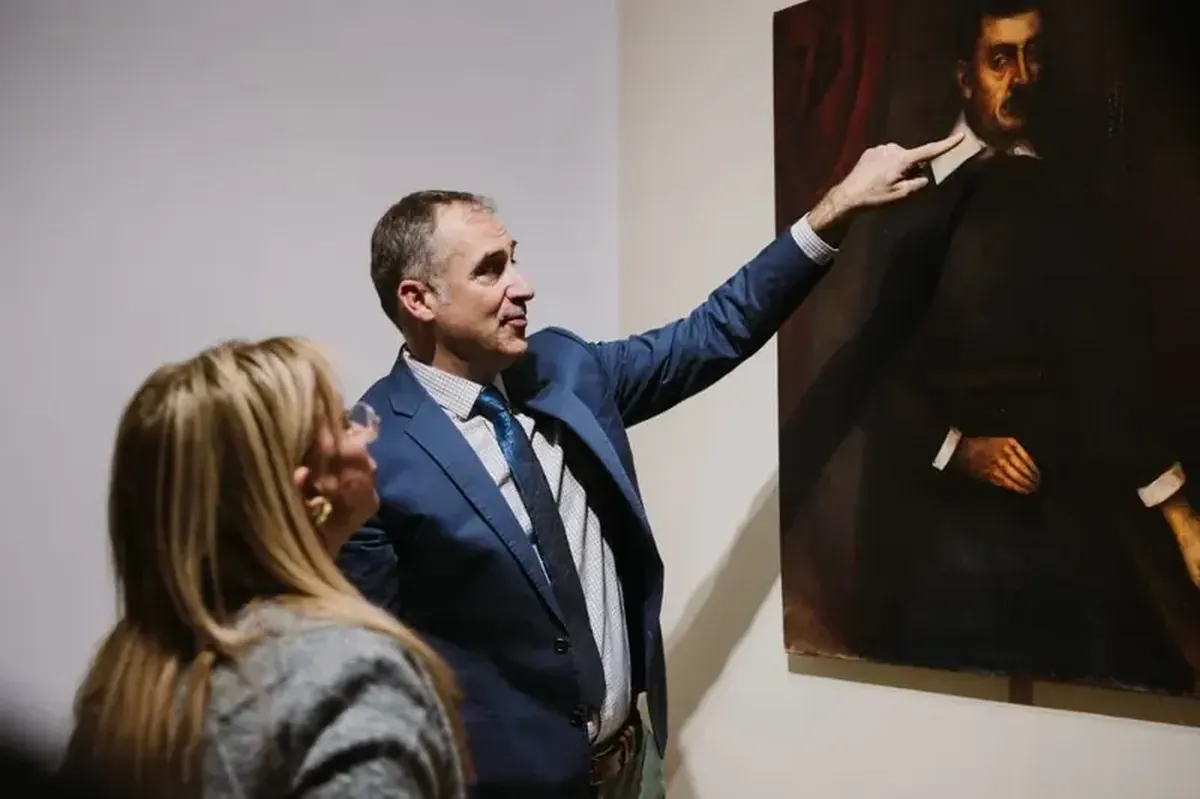 Beneath Titian's masterpiece lay a portrait of a man with books.