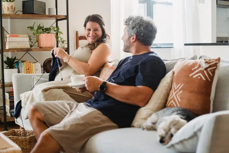 A couple talking while sitting on a couch