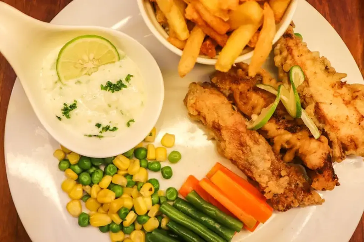 fried chicken and fries on white ceramic plate