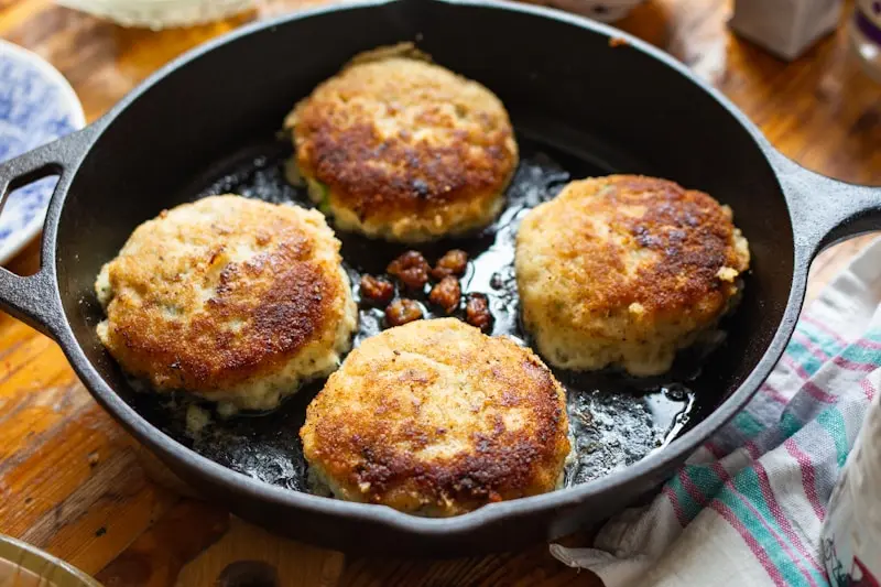 A pan filled with food on top of a wooden table