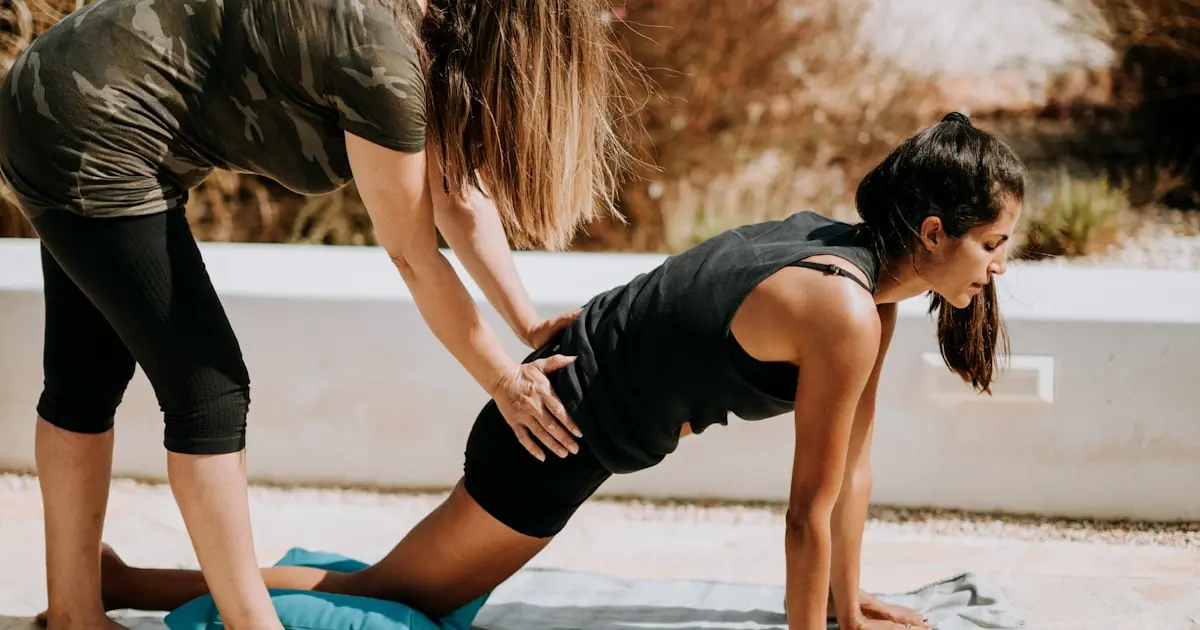 woman in black tank top and black shorts kneeling on mat
