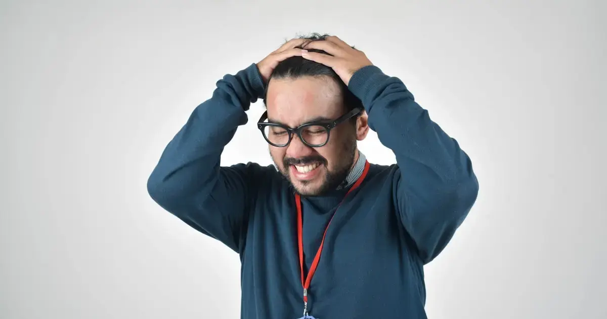 man in stress holding his head