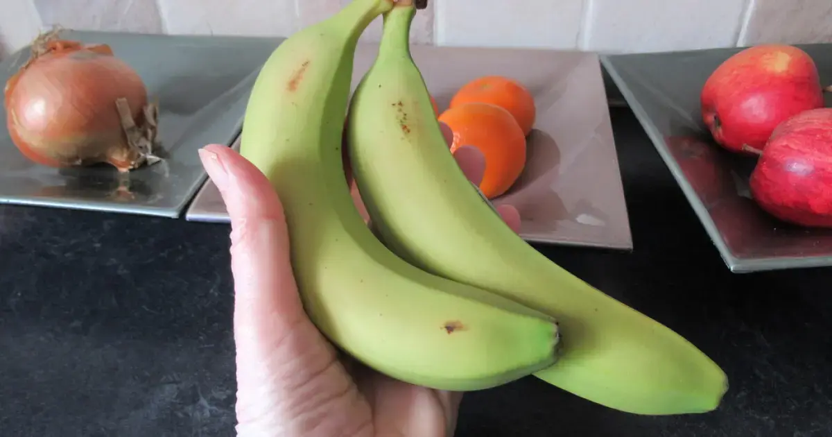 green bananas in hand