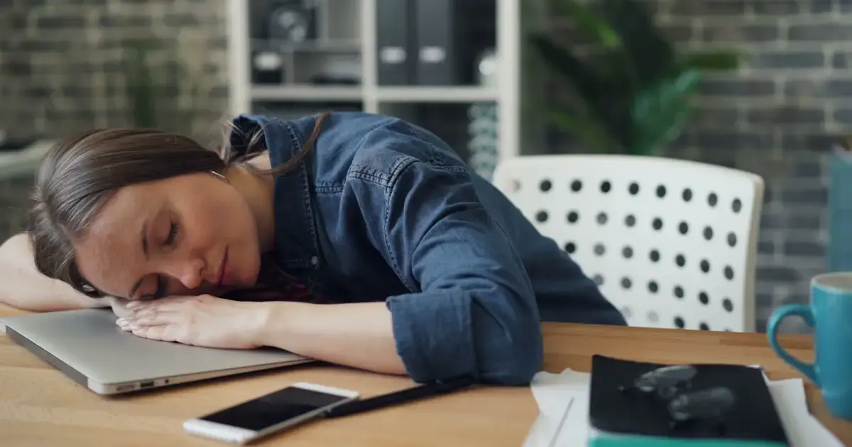 woman sleeping by a laptop
