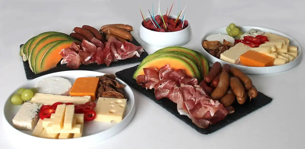 Cheeses, sausage, and smoked meat on a table