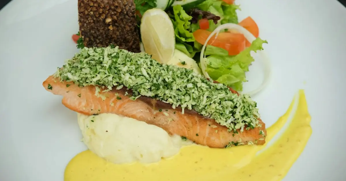 a white plate topped with a sandwich and a salad