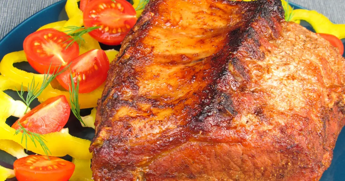 a blue plate topped with meat and vegetables