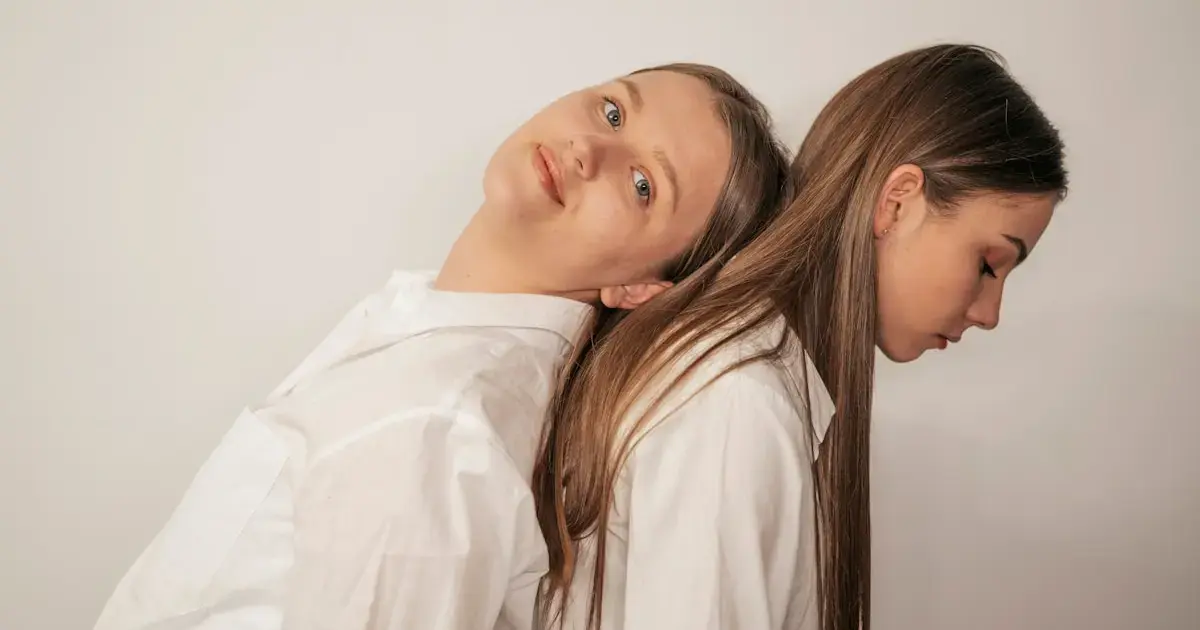 a woman resting her head on another woman's shoulder