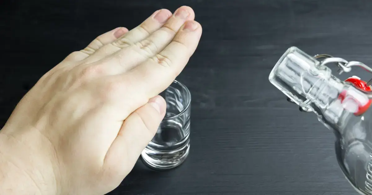 a hand covering a glass