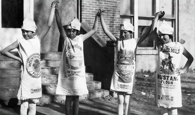 Children in clothing made from sacks