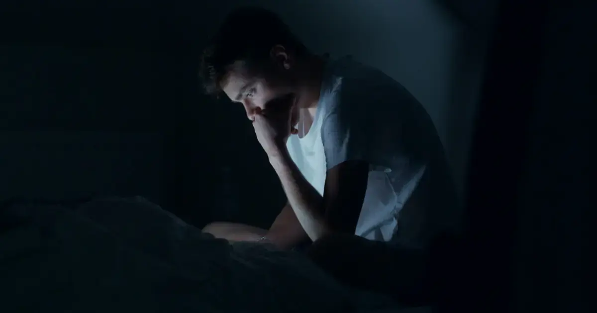 man unable to sleep at night in bed