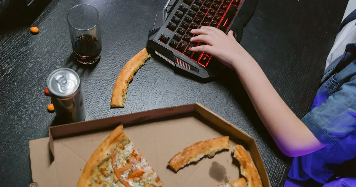 pizza in a box next to a keyboard