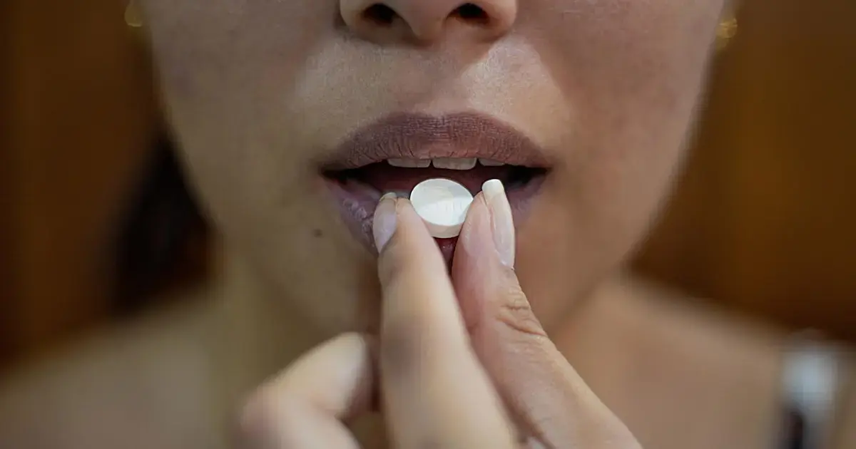 Woman taking a pill