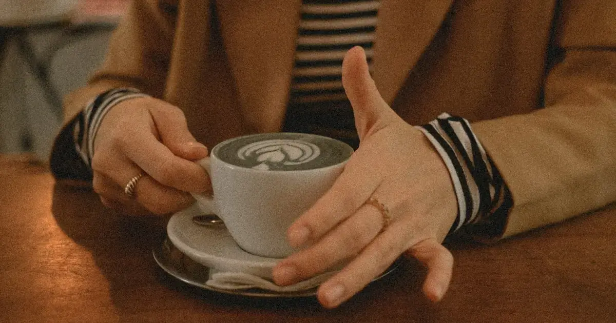 Woman gently strokes a cup with her finger