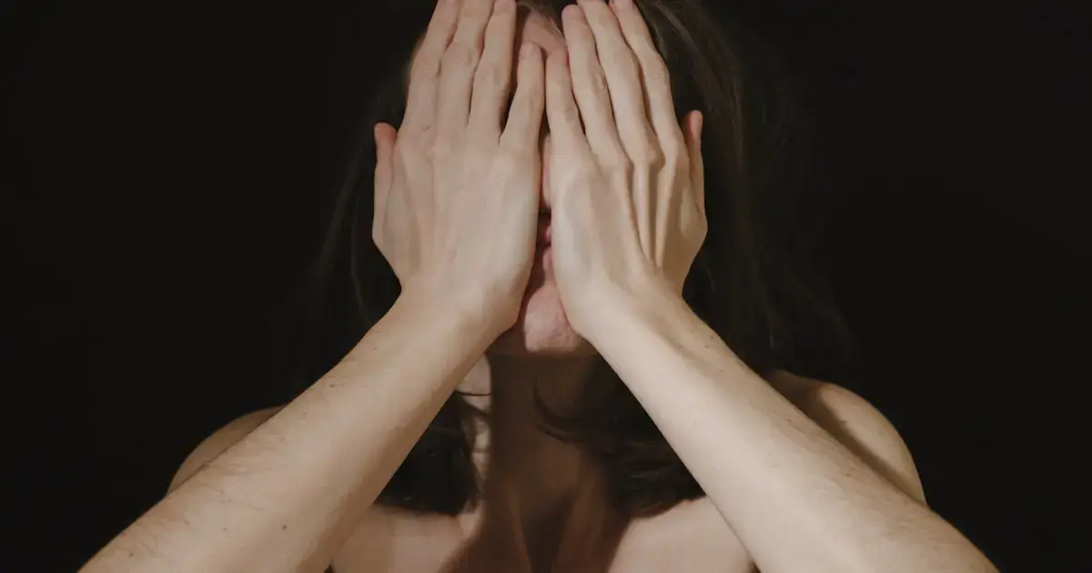 woman covering her face with her hands