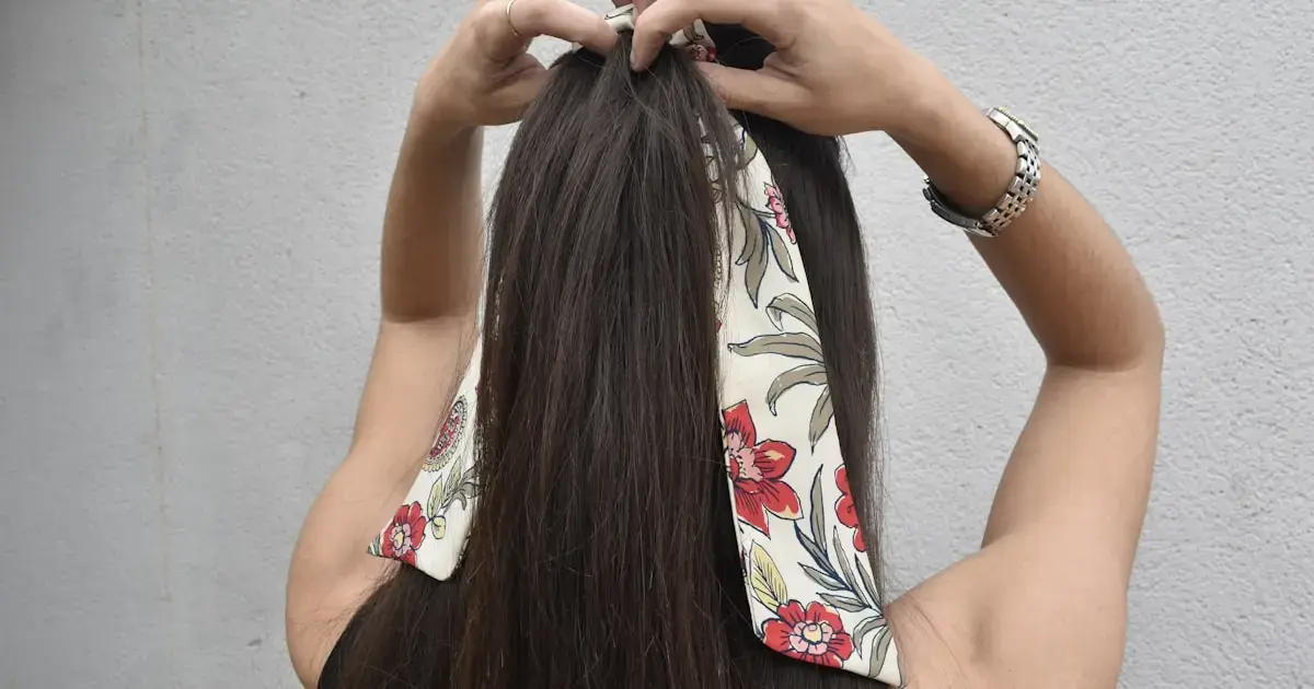 woman styling a ponytail