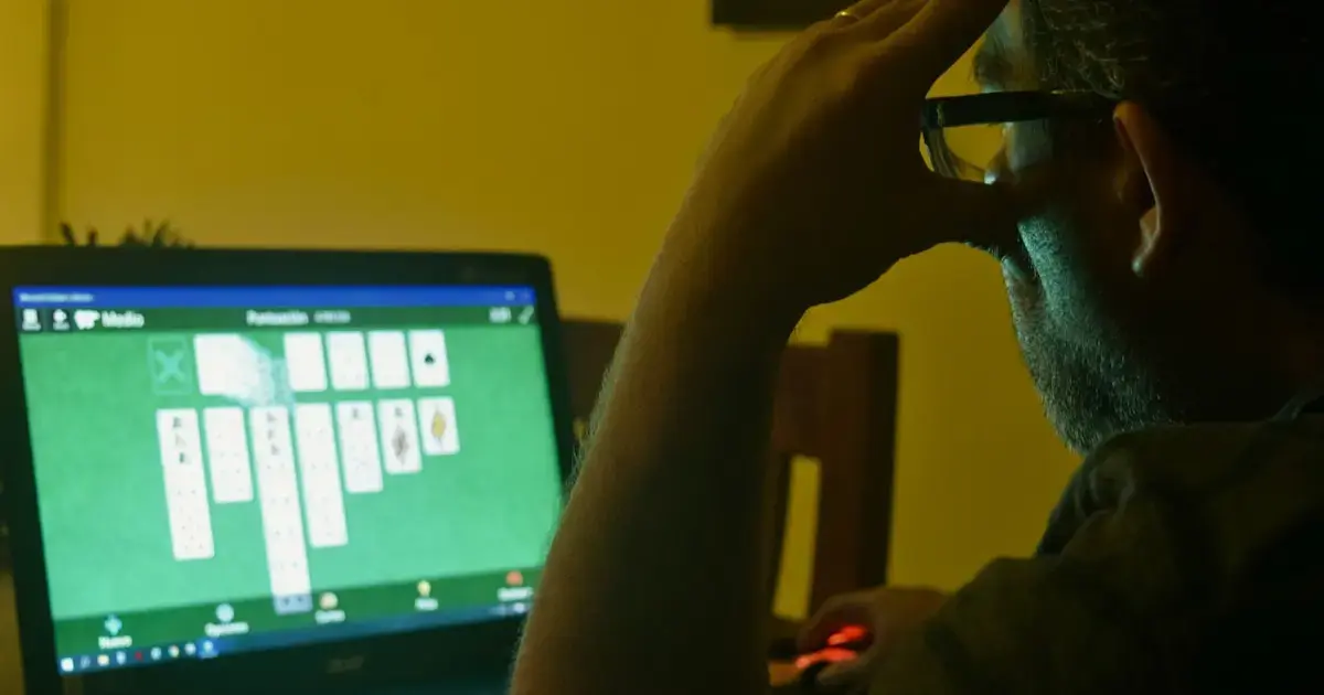 Man sitting at home by a laptop