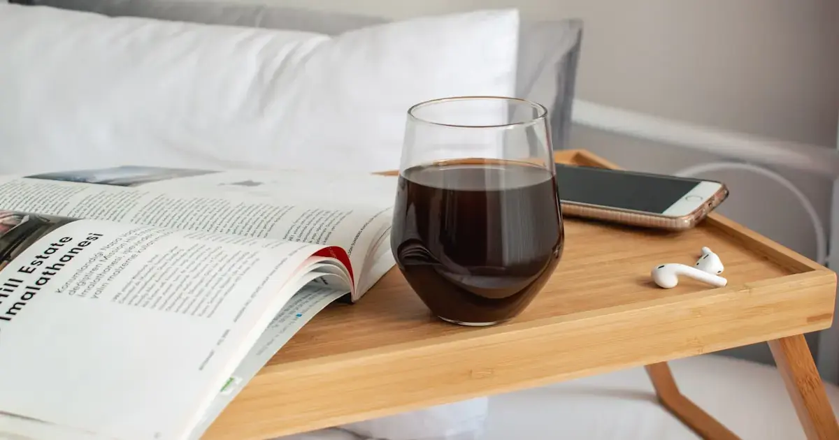 a glass of wine on a bedside table