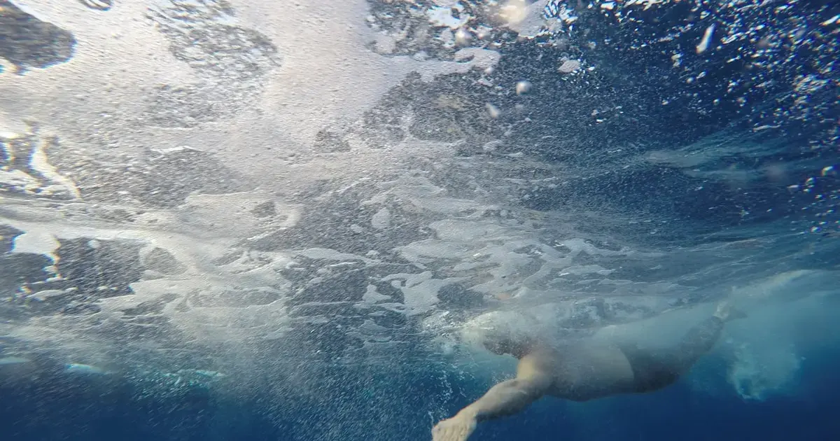 person swimming underwater