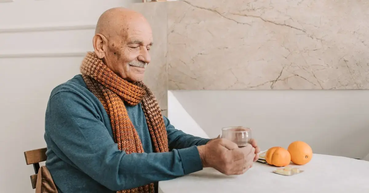 an elderly man at a table