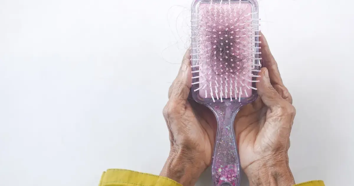 woman holding a brush with hair