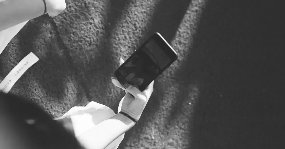 woman standing with a smartphone in hand