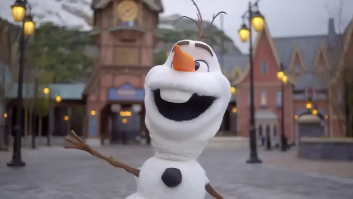 Olaf the snowman with artificial intelligence strolling through Disneyland Paris