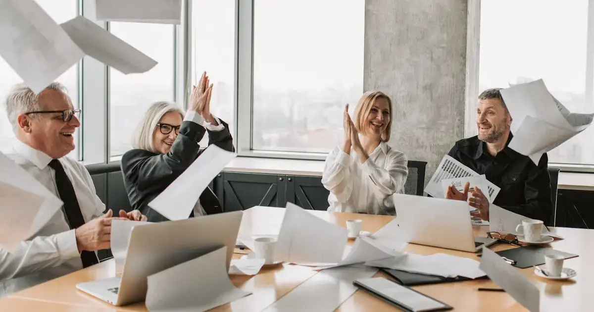 A group of cheerful people in an office around a table