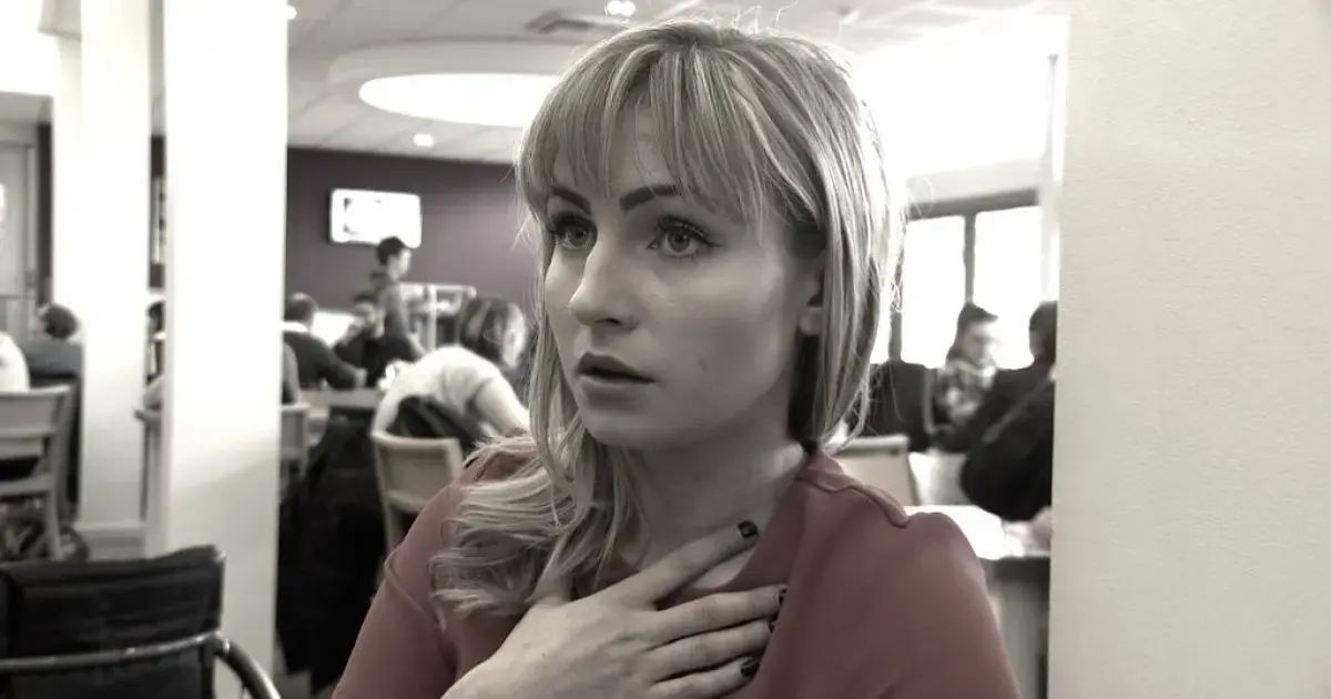 Woman holding her hand on her chest