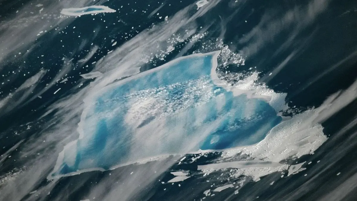 As it ages, a 40-year-old iceberg suddenly turns blue