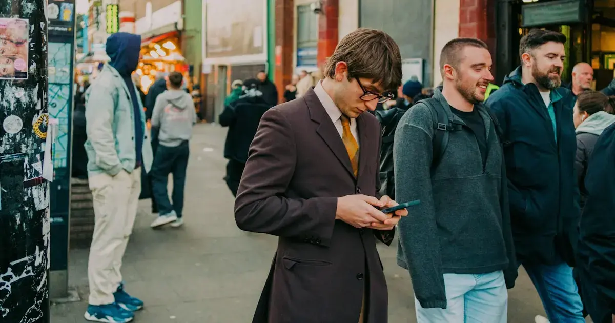 A man walking down the street with a smartphone