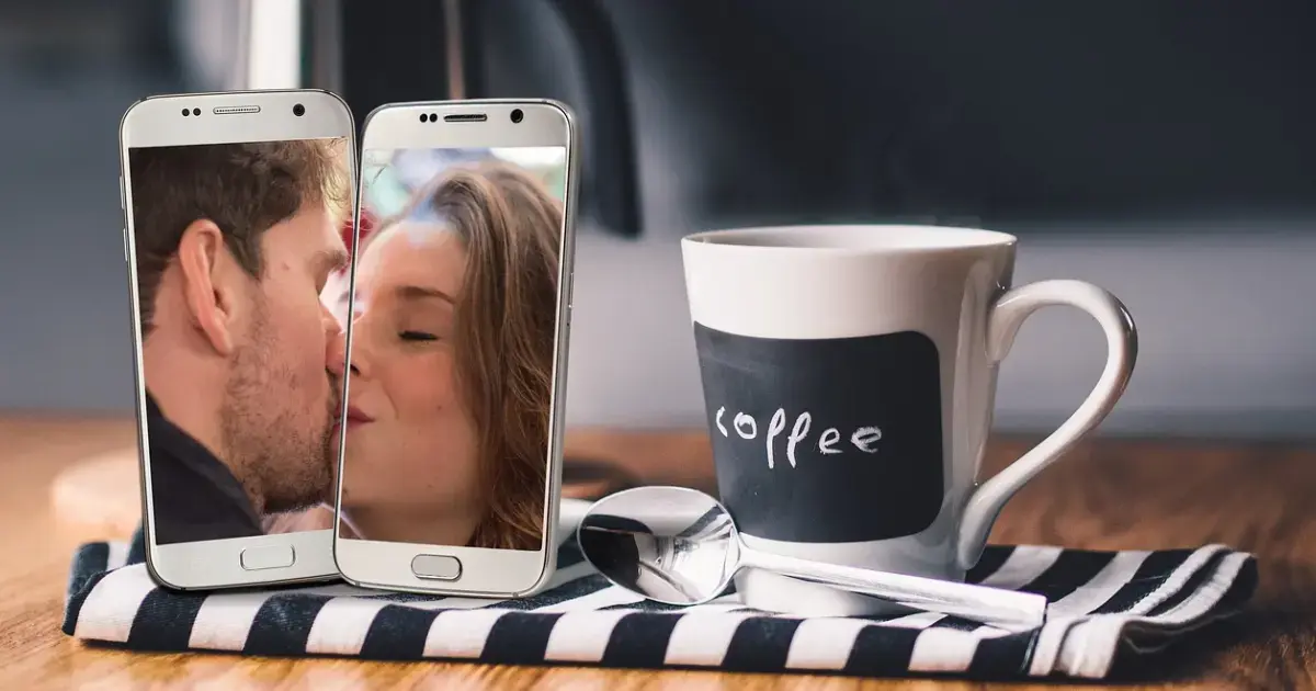 Two smartphones and a cup of coffee