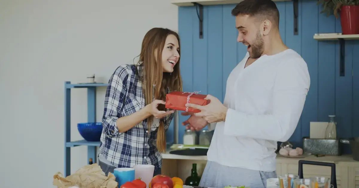 A woman giving a gift to a man