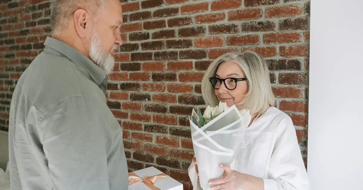 A man giving a woman flowers and a gift