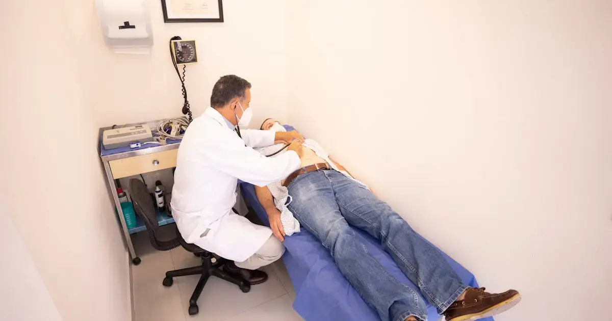 doctor examining patient's abdomen