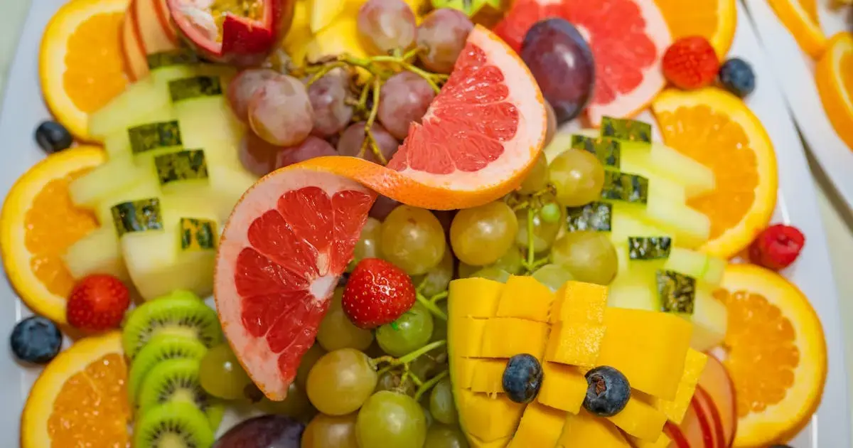 sliced fruits and berries on a plate