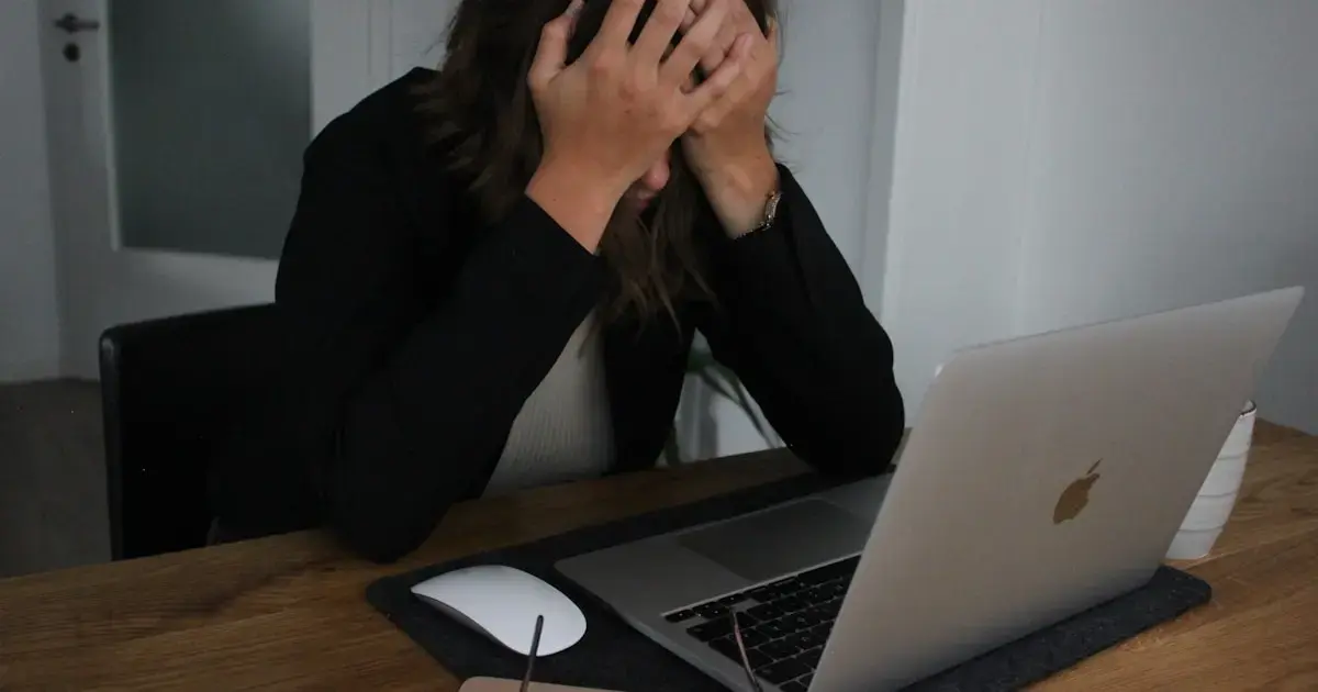 woman covering her face with her hands