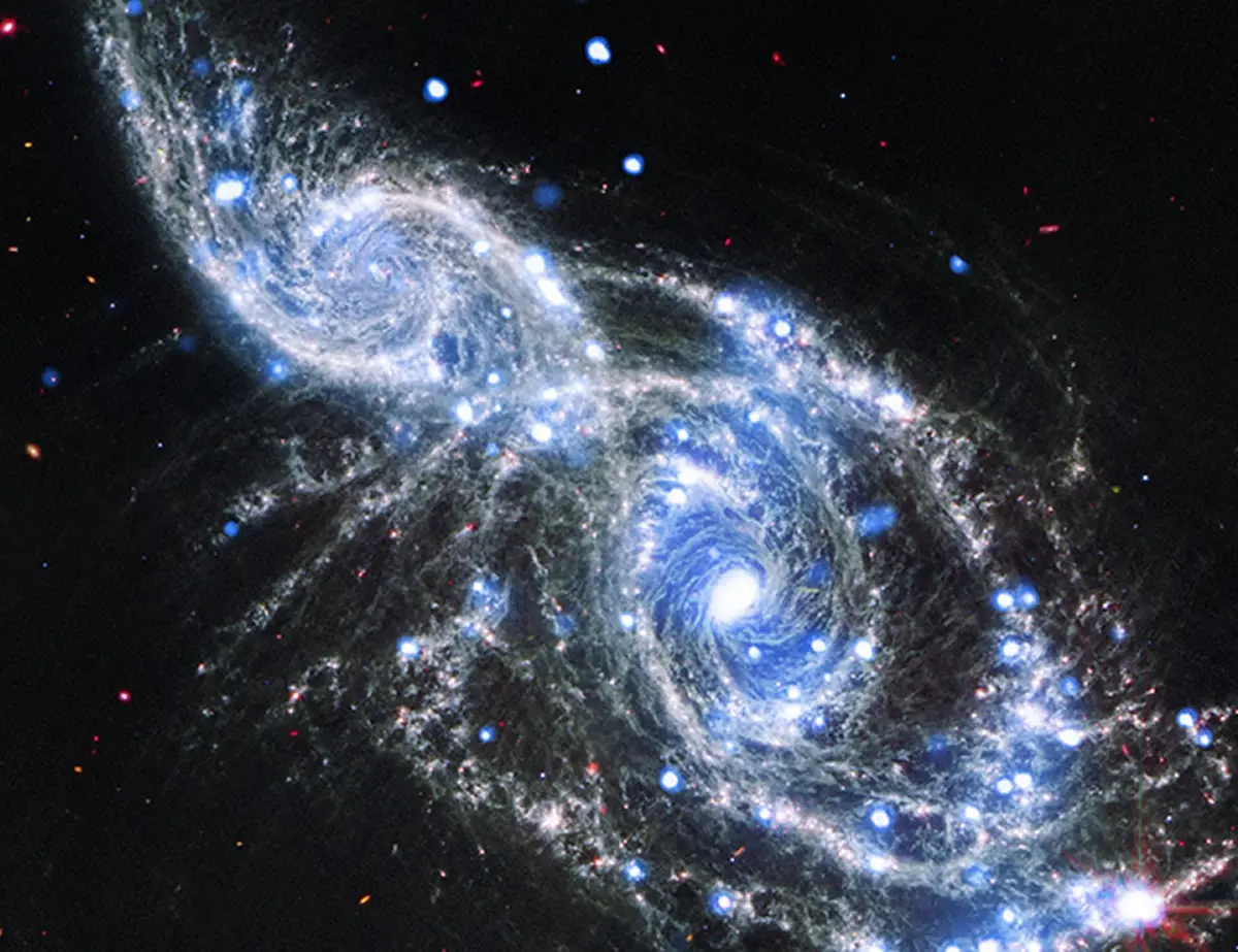 The enchanting web of chaos captured by the James Webb Telescope during a galaxy merger
