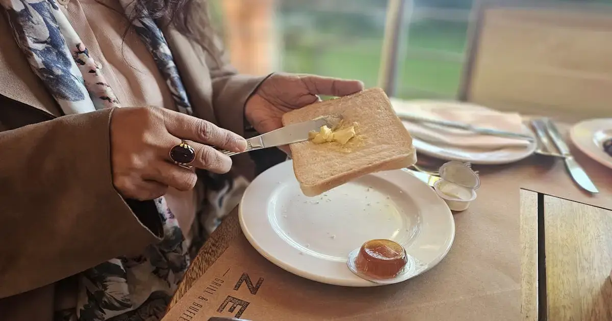 a person spreading butter on bread