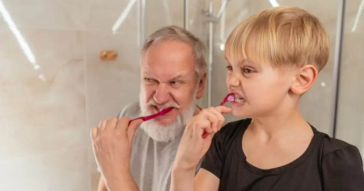 grandfather and grandson brushing teeth