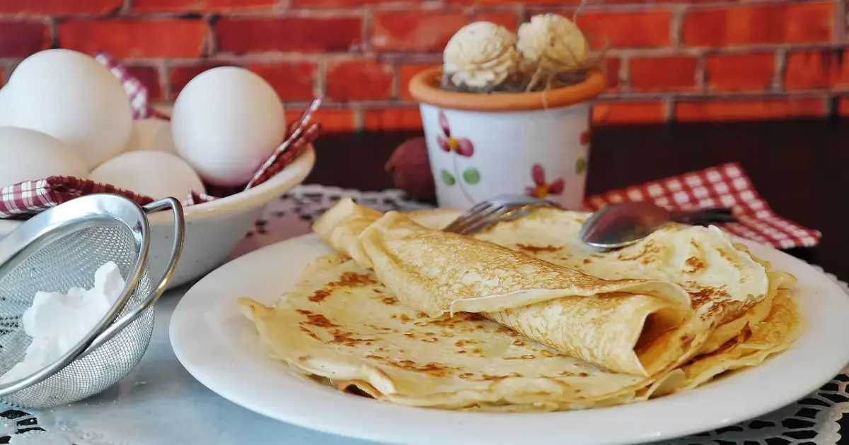 flour, eggs, pancakes on a plate