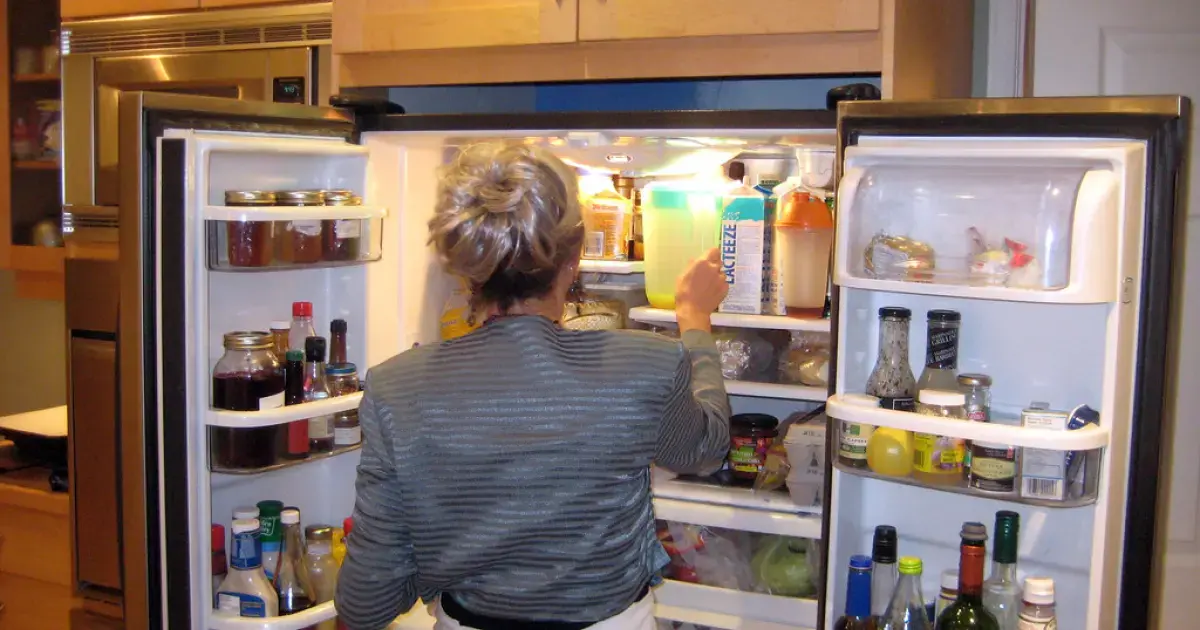 woman taking juice from the fridge