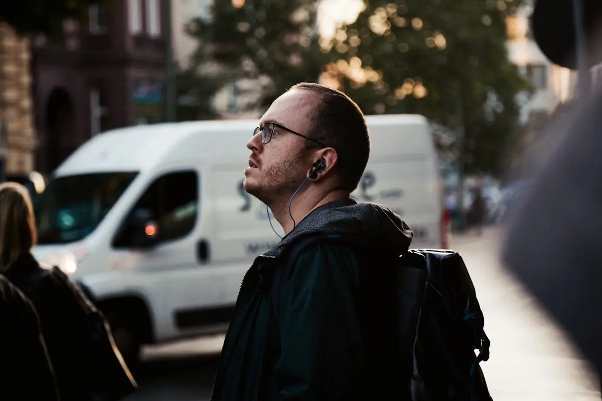 Man walking down the street wearing headphones
